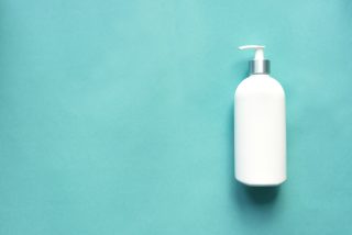 White Dispenser Soap or Hand Sanitizer on Blue