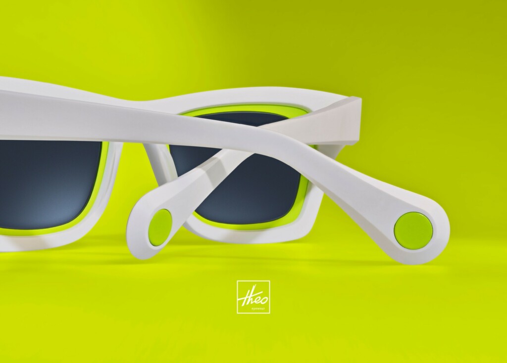 White rimmed Theo sunglasses displayed with a neon green background