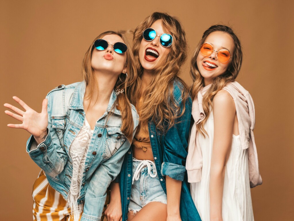 Three happy women wearing their designer sunglasses